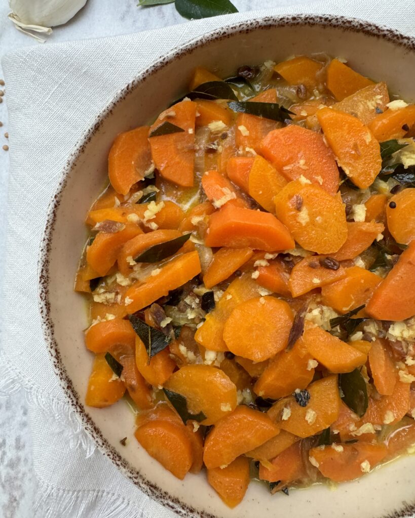 Carrot curry in a rich coconut sauce with aromatics and grated coconut