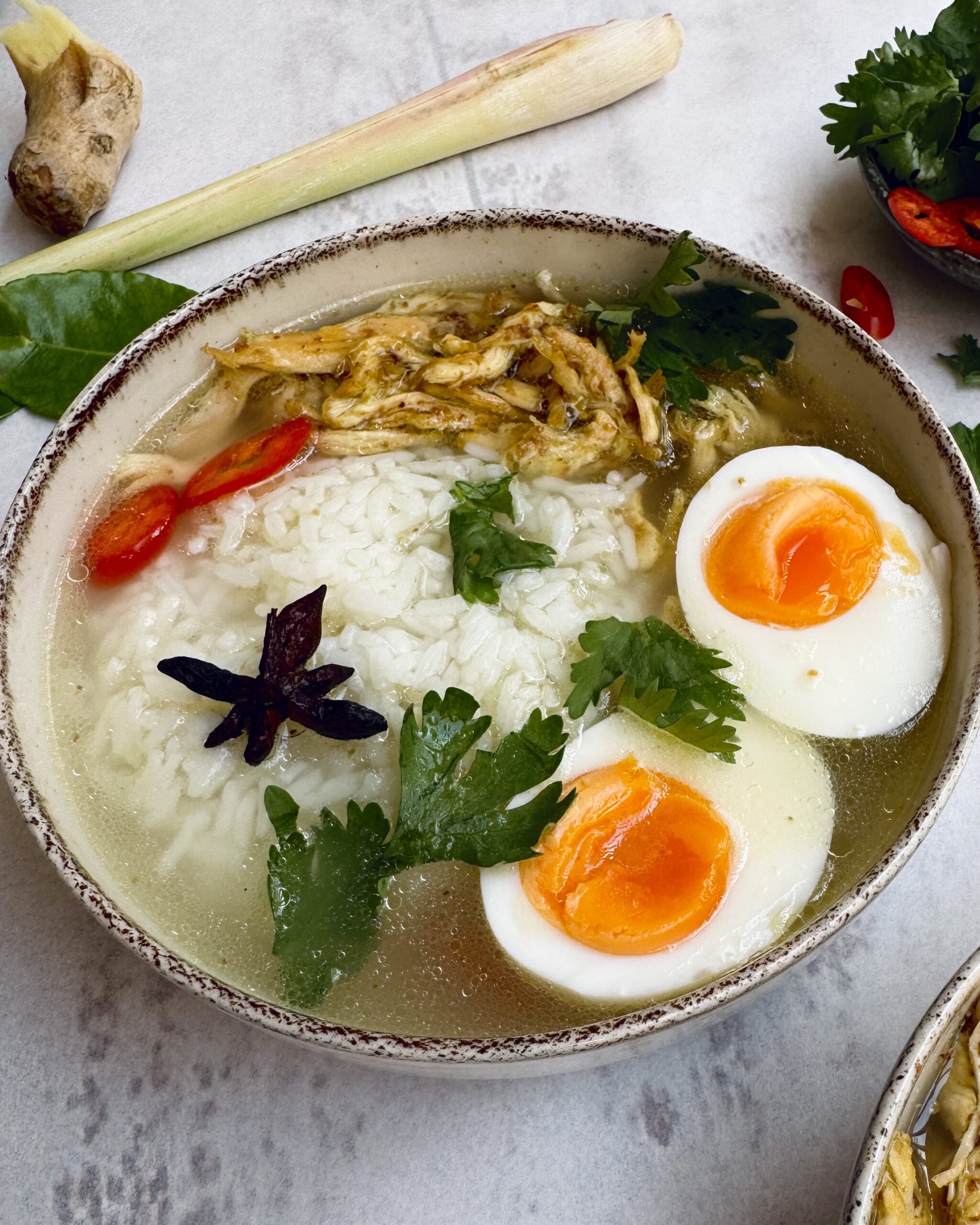 brothy rice with shredded chicken, eggs and cilantro and thai spices