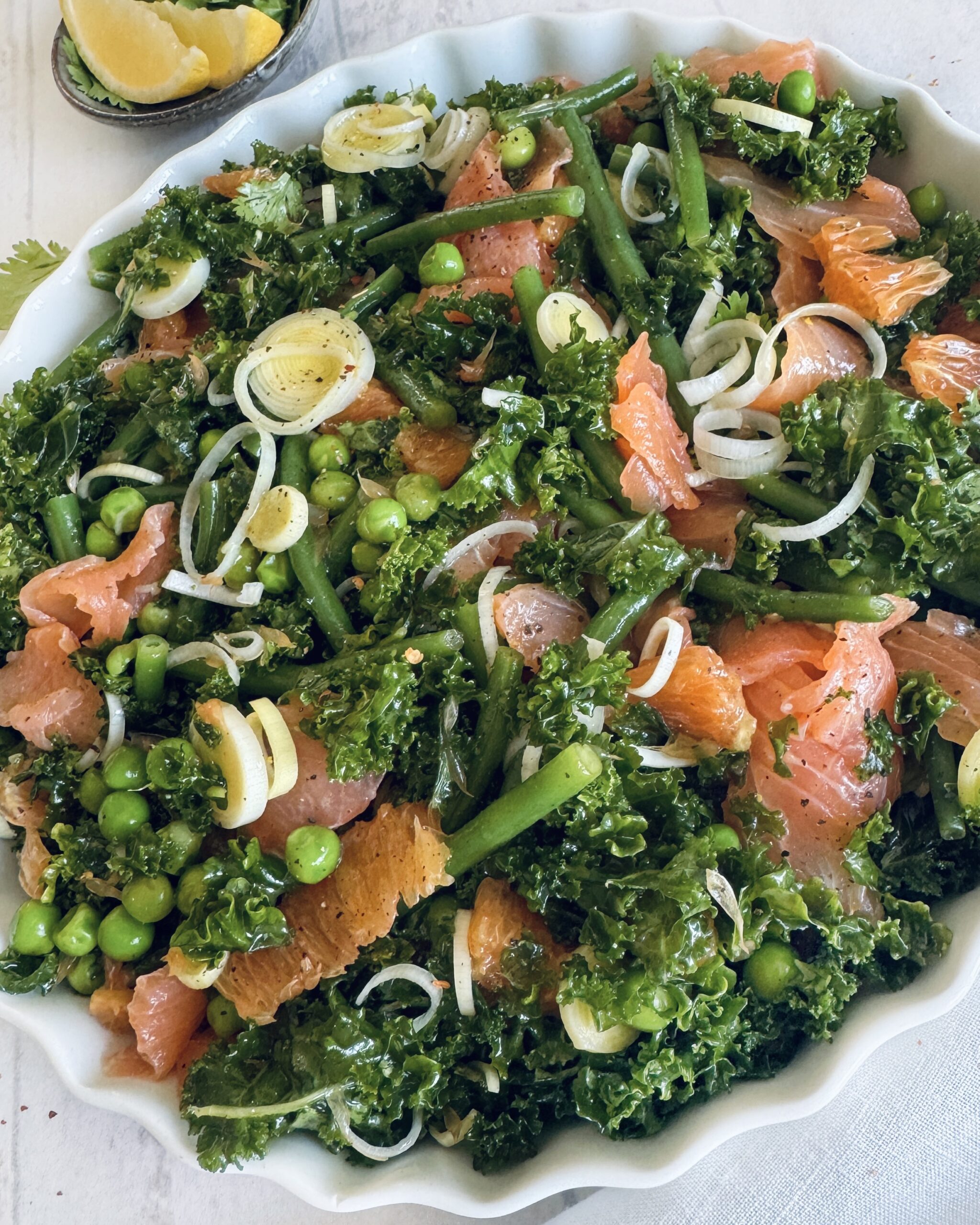 smoked salmon salad with orange and green vegetables
